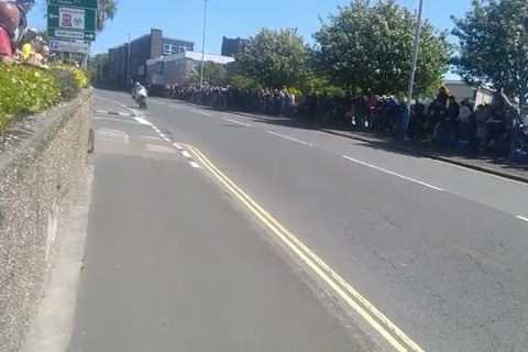 Heartstopping moment football rolls down hill as Isle of Man TT riders zoom past in narrow miss while at 130mph